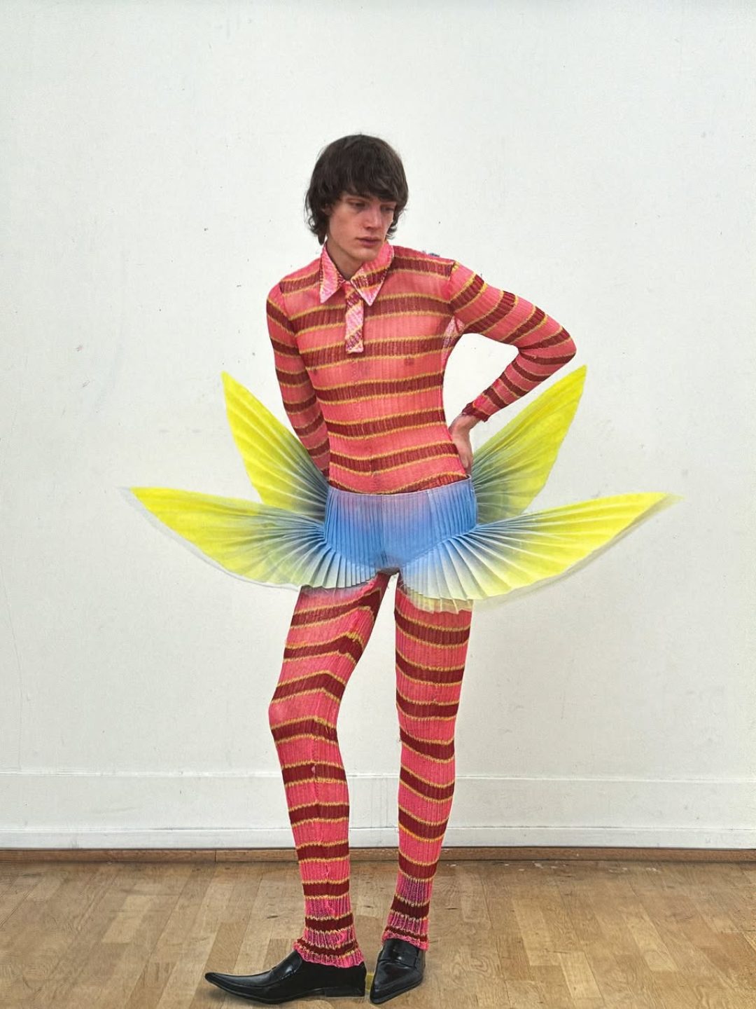 closingthiscollectionwithhector.herodywearingaknittedpolobodysuitandpleatedpaperwi